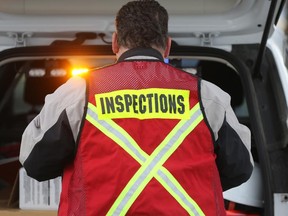 An investigator probes an industrial accident in Calgary at the 600 block of 28th Street N.E. as a wall is believed to have collapsed on a worker on Nov. 20, 2014.