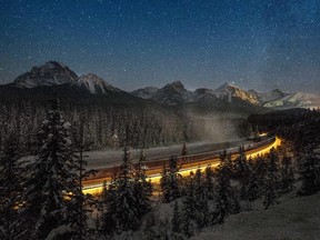 Cargo train passes through the famous 'Morant's Curve'  offering a beautiful view of the frozen Bow River and the Canadian Pacific Railway in Banff National Park near Lake Louise, Canada, late on December 6, 2013.