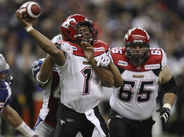 Quarterback Henry Burris of the Calgary Stampeders throws under pressure from John Bowman of the Montreal Alouettes.