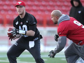 Colleen De Neve/ Calgary Herald CALGARY, AB --NOVEMBER 17, 2014 -- Calgary Stampeders quarterback Bo Levi Mitchell, left, and running back Jon Cornish practiced with teammates during a walk through on the turf at McMahon Stadium on November 18, 2014 in advance of the Western Final this weekend. (Colleen De Neve/Calgary Herald) (For Sports story by Rita Mingo) 00060511A SLUG: 1119-Stamps Practice