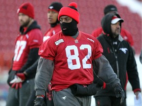 Calgary Stampeders slotback Nik Lewis bundled up as he practiced with teammates during a walk through on the turf at McMahon Stadium on November 18, 2014 in advance of the Western Final this weekend.