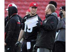New Calgary Stampeders head coach Dave Dickenson, right, will be picking his challenges wisely given new video-review rules in the CFL this season. (File)
