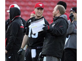 Calgary Stampeders quarterback Bo Levi Mitchell got instructions from offensive coordinator Dave Dickenson as he practised with teammates during a walk through on the turf at McMahon Stadium on November 18, 2014 in advance of the Western Final.