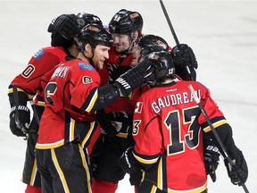 Colleen De Neve/ Calgary Herald CALGARY, AB --NOVEMBER 18, 2014 -- Calgary Flames defenceman Dennis Wideman, left, celebrated with teammates, clockwise from left, centre Markus Grandlund, defenceman Ladislav Smid, centre Paul Byron and left winger Johnny Gaudreau after scoring the Flames third goal of the game and Wideman's second against the Anaheim Ducks during third period NHL action at the Scotiabank Saddledome on November 18, 2014. The Flames defeated the Anaheim Ducks 4-3 in overtime. (Colleen De Neve/Calgary Herald) (For Sports story by Scott Cruickshank) 00056694A  SLUG: 1119-Flames Ducks ORG XMIT: A65W7126.JPG