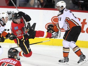 Colleen De Neve/ Calgary Herald CALGARY, AB --NOVEMBER 18, 2014 -- Calgary Flames centre Markus Granlund was sent flying through the air by Anaheim Ducks right winger Kyle Palmieri during second period NHL action at the Scotiabank Saddledome on November 18, 2014. (Colleen De Neve/Calgary Herald) (For Sports story by Scott Cruickshank) 00056694A  SLUG: 1119-Flames Ducks ORG XMIT: A65W6478.JPG