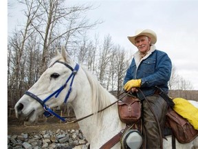 Cowboy Len Crow and his trusted horse, Music, takes a moment from his ride to pose for a photo just outside of Turner Valley on Friday November 7, 2014. Cowboy Len Crow will be riding from Alaska to Mexico to raise money for orphans in Mexico, Guatemala, Cambodia, India, and the Philippines.