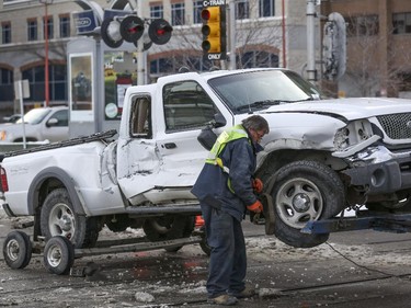 Crews work on the C-train that struck a truck while crossed the street at the intersection of 9 Street SW and 4 Avenue SW in Calgary, on November 20, 2014. --