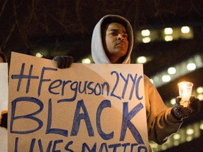 Habtamu Hailu shows his support for Ferguson as part of the 'Black Lives Matter' protest in Calgary on Tuesday, November 25, 2014.