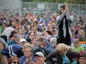 Stuart Gradon/Calgary Herald  CALGARY, AB: July 25, 2014 - Audience members applaud an afternoon session at the National stage at the Calgary Folk Music Festival in Calgary, Alberta Friday, July 25, 2014.  (Stuart Gradon/Calgary Herald)   (For Entertainment story by Mike Bell) 00057441A