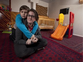 Karolyn Slowsky and her 9 year old son Mackenzie in the day-home that Mackenzie goes to before and after school, taken on November 19, 2014 in Edmonton.  It is extremely difficult for families to get daycare in Alberta, based on an exclusive study that looks at wait lists and difficulties for families that have infants and disabled kids.