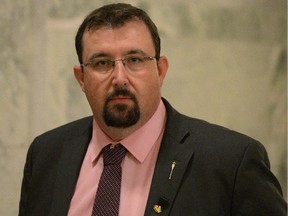 Former Alberta Wildrose Party member Ian Donovan walks through the Alberta Legislature  on Nov. 25, 2014, one day after he and Kerry Towle left the Wildrose to join the Progressive Conservative Party.