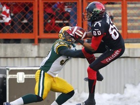 Calgary Stampeders' Eric Rogers, right, makes a touchdown catch beside Edmonton Eskimos' Otha Foster during 2nd quarter CFL Western Final action in Calgary, Ab., on Sunday Nov. 23, 2014.