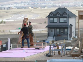 Construction workers build homes in Nolan Hill.