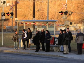 Commuters wait for Calgary Transit buses at the Heritage LRT CTrain station.