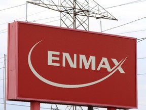 FILE PHOTO: CALGARY, AB: NOVEMBER 05, 2014 --  STK. Powerlines rise behind an Enmax sign at the company's head office in Calgary. Gavin Young/Calgary Herald