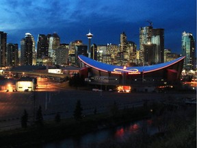 Gavin Young, Calgary Herald CALGARY, AB: NOVEMBER 05, 2014 -- STK. Scotiabank Saddledome with downtown Calgary in the background. (skyline, dusk) Gavin Young/Calgary Herald (For City section story by ) Trax#