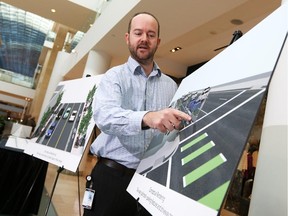 Thomas Thievener, Calgary's bicycle coordinator displays  proposed designs for new cycle tracks in the city's downtown and Beltine.