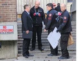 Gavin Young, Calgary Herald 
 CALGARY, AB: OCTOBER 31, 2014 -- Police investigate the scene of an officer involved shooting at Calgary Housing's Langin Place apartment building in downtown Calgary early Friday morning Oct. 31, 2014. One man was declared dead on the scene. 
 Gavin Young/Calgary Herald 
 (For City section story by Clara Ho) Trax#