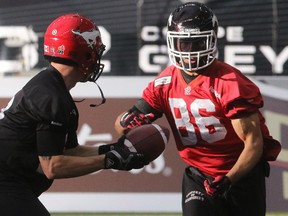 Calgary Stampeders wide receiver Anthony Parker takes a hand-off from quarterback Bo Levi Mitchell during practice at BC Place on Friday.