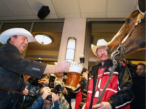 Calgary City Councillor Joe Magliocca sees if mare Alley will try some beer after she was ridden into the Holiday Inn in downtown Vancouver on Friday November 28, 2014.