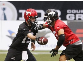 Quarterback Bo Levi Mitchell hands off to running back Jon Cornish during practice at B.C. Place on Friday November 28, 2014.