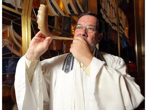 Rabbi Shaul Osadchey with a ram's horn at the Beth Tzedec Congregation in Calgary.