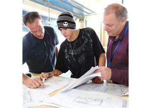 Grade 12 student Trueman Hughes is flanked at a tool box meeting by teacher Mike Coleman, left, and principal Bill Bobenic.