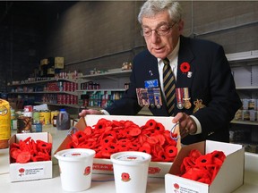 Joey Bleviss, CEO of the Calgary Poppy Fund, organizes poppies in the food bank area at the poppy fund's Calgary office.