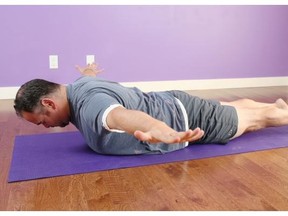 Hart Steinfeld demonstrates the cobra pose, bhujangasana with chest, head and arms lifted off the floor. Arms open wide out to the sides like your flying.
