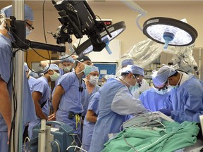 File - doctors in Cleveland, Ohio perform surgery.