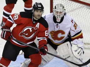 New Jersey Devils' Jaromir Jagr (68), of the Czech Republic, plays in front of Calgary Flames goalie Karri Ramo (31), of Finland, during the third period of an NHL hockey game in Newark, N.J., Monday, April 7, 2014. The Flames won 1-0.