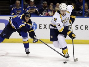 St. Louis Blues defenceman Jay Bouwmeester battles for the puck with Nashville's Filip Forsberg during a Nov. 13 game. After missing Sunday's game vs. Winnipeg, the former Flames star saw his incredible ironman streak end.