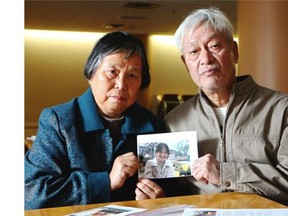 Jinling Huang and her husband Zhiming Chen hold a photo of their daughter Yinghua Chen, a Fulun Gong practitioner imprisoned in the Number 2 Shijiazhuang Detention Centre in China. She came to the Herald with translator Jenny Yang Friday November 7, 2104.