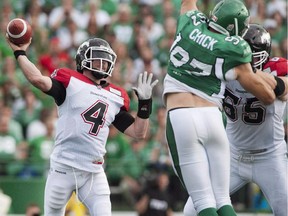 Calgary Stampeders offensive lineman Dan Federkeil, right, keeps Saskatchewan's John Chick at bay while quarterback Drew Tate throws a pass during a game last season.