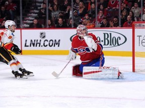 Josh Jooris of the Calgary Flames scores his second goal of the game against Carey Price, roofing it while skating in on a breakaway.