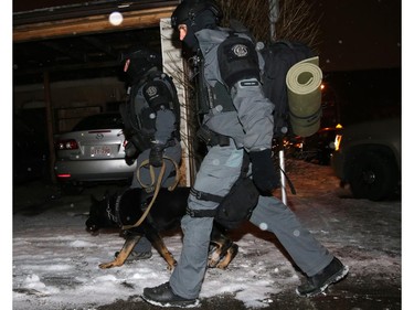 The police tactical unit bring out the K9 unit as they investigate an armed robbery at the Bank of Montreal  in Mission on Wednesday.