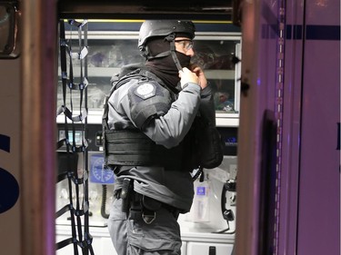 An EMS member suits up at an armed robbery at the Bank of Montreal, 2302 4th Ave S.W., on Wednesday.