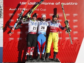 Norway's Kjetil Jansrud, right, celebrates his win with second place tied finisher Canada's Manuel Osborne-Paradis, left, and France's Guillermo Fayed following the men's World Cup downhill ski race in Lake Louise, Alta., Saturday, Nov. 29, 2014.