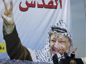 Palestinian President Mahmoud Abbas addresses supporters during a ceremony marking the 10th anniversary of the late Palestinian leader Yasser Arafat's death, at the his headquarters in the West Bank city of Ramallah, Tuesday, Nov. 11, 2014.