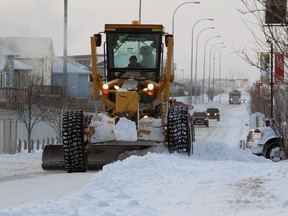 A snow plow cleans up along 80th avenue in the Saddleridge area of northeast Calgary on Thursday December 5, 2013.