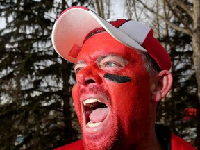 Calgary Stampeders fan Jason Raber cheers on the Stamps as they take on the Edmonton Eskimos during the West Final at McMahon Stadium in Calgary on Nov. 23, 2014.