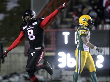 Calgary Stampeders Fred Bennett, left, celebrates his play against the Edmonton Eskimos during the West Final at McMahon Stadium in Calgary.