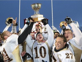 The Manitoba Bisons celebrate winning the 2014 Canada West Hardy Cup at McMahon Stadium.