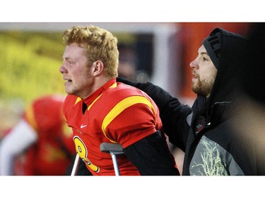 Calgary Dinos quarterback Andrew Buckley, who was injured in the second half, shows the emotion of watching his team lose to the Manitoba Bisons during the final moments of the Hardy Cup at McMahon Stadium on Saturday.