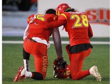 Calgary Dinos Elie Bouka, left and Hunter Turnbull console each other after losing the 2014 Canada West Hardy Cup to the Manitoba Bisons.