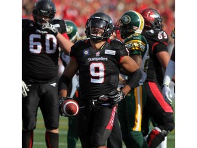 Stamps running back Jon Cornish hangs onto the ball after scoring the final touchdown of the game as the Calgary Stampeders  won 28 to 13 over  the Edmonton Eskimos in the annual Labour Day Classic at McMahon Stadium on September 1, 2014. (Lorraine Hjalte/Calgary Herald) For Sports story by . Trax # 00057414A