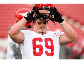 Calgary Stampeders offensive lineman Brett Jones put his helmet back on for drills as he practiced with teammates at McMahon Stadium in October 30, 2013 in preparation for their game against the Lions on Friday.