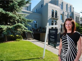 Realtor Julie Dempsey stands outside one of her listings in the Lindsay Park Place building in the Mission area of Calgary on July 10, 2014.