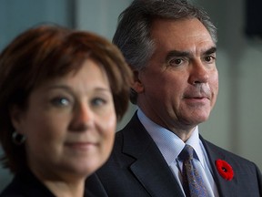 B.C. Premier Christy Clark, left, and Alberta Premier Jim Prentice listen during a news conference after they met at the premier's office in Vancouver on Monday.