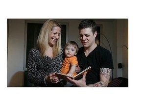 Nicolas Deveaux, right, and common-law partner Marjolaine Goulet hold son Lionel to read a book at home.